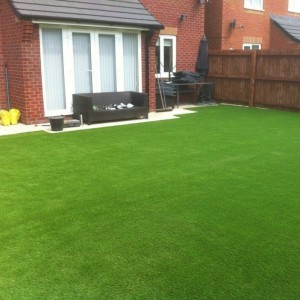 Garden completed in playtime artificial grass £12 square metre, 4 mt wide plus ground work.